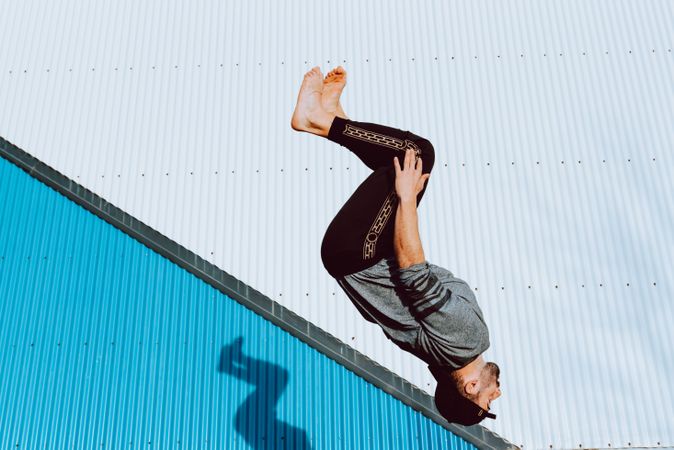 Trendy male flipping on street