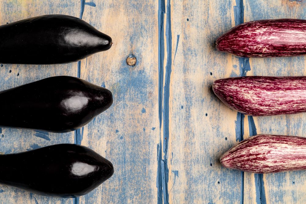 Ripe eggplants on shabby tabletop