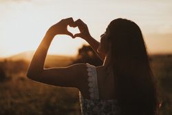 Woman making heart shape with hands