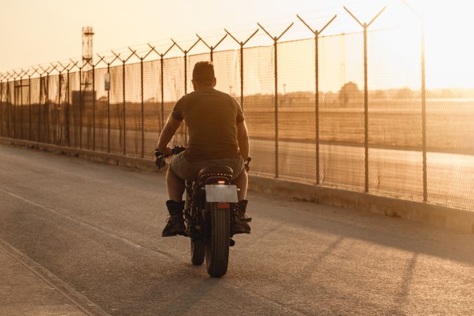 Strong man driving motorcycle