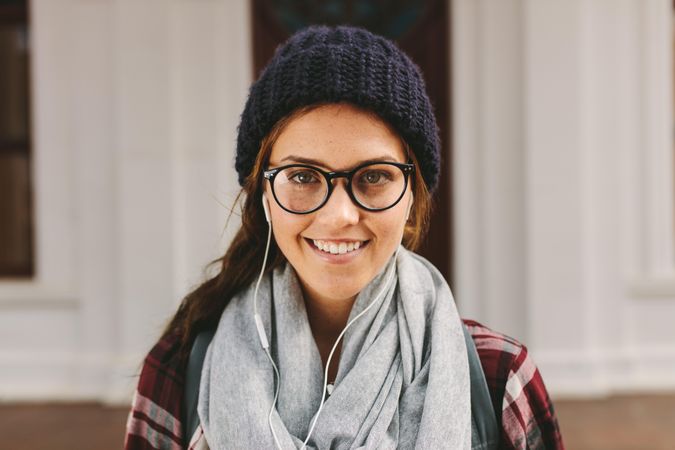 Portrait of female student wearing a beanie and scarf on college campus