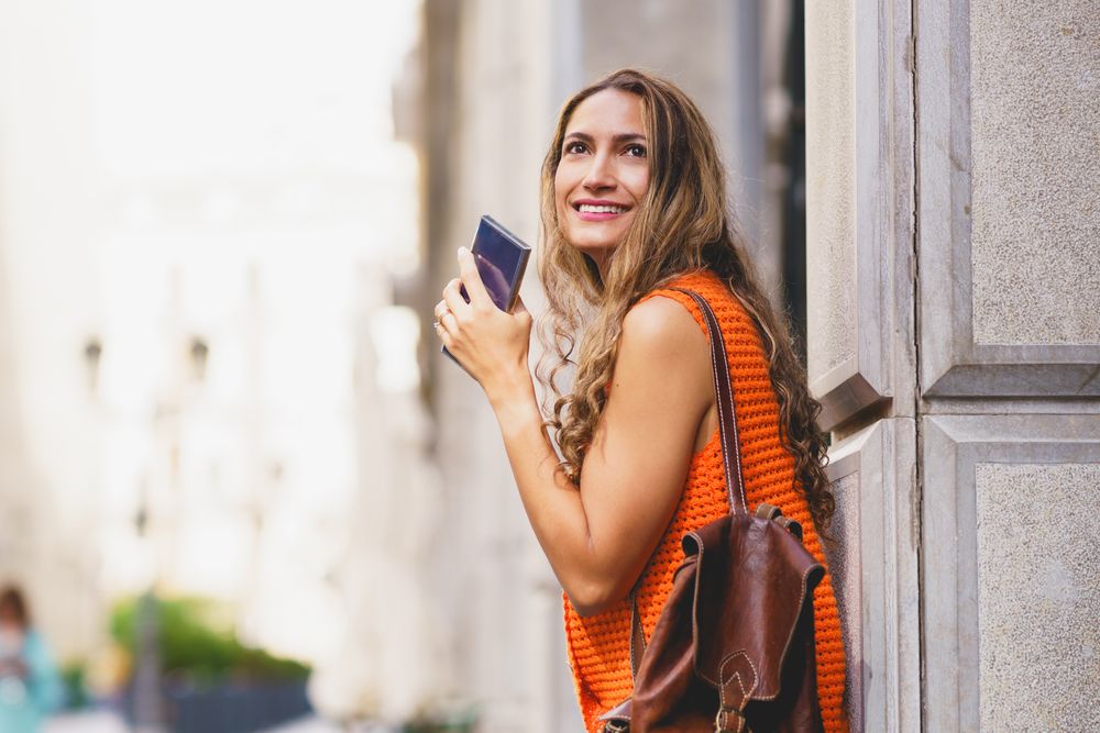 Woman looking around with phone