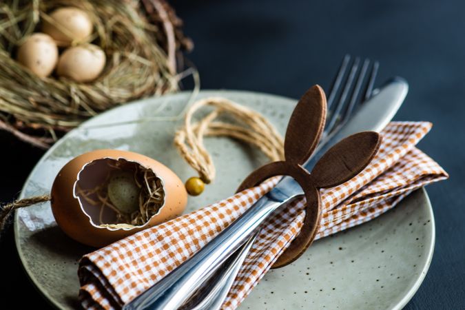Eater table setting with decorative egg shell and checkered napkin in a rabbit ring