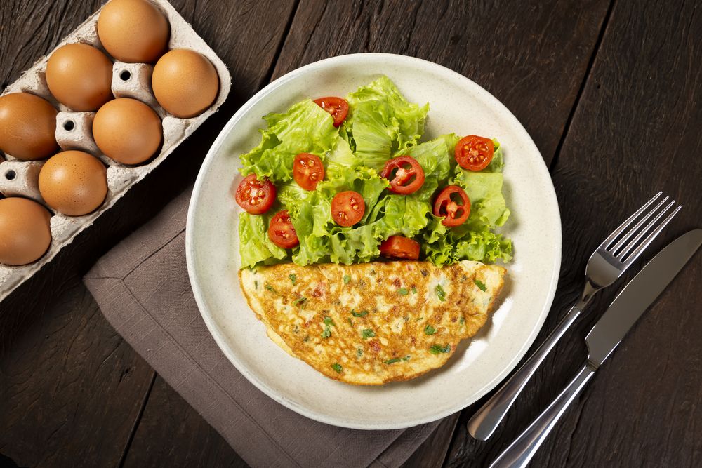 Omelet with cheese and lettuce and tomato salad.