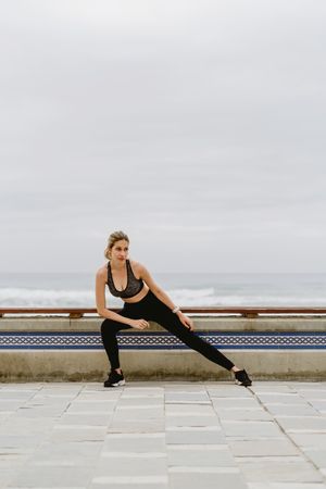 Sportswoman working out at city street