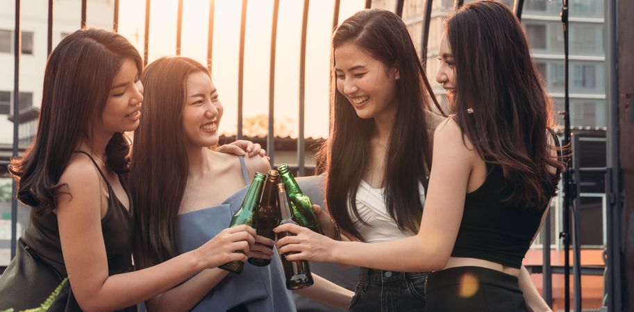 Group of Asian women celebrating and toasting drink together at the party