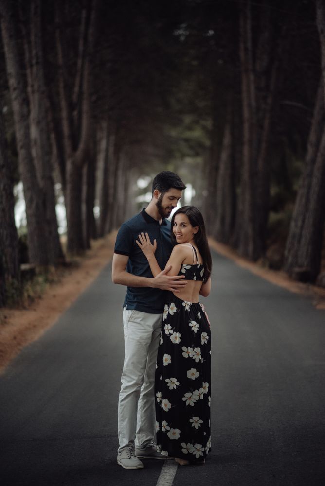 Loving couple embracing on pathway in misty forest