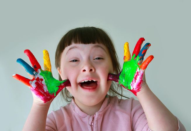 Excited little girl with painted hands