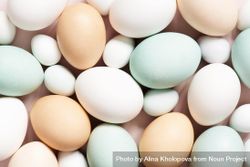 Close up of different colored eggs on pink background 4dd3a4