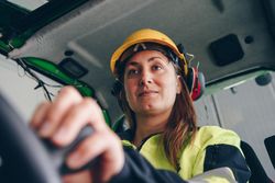 Woman in yellow helmet driving a vehicle
