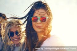 Woman in reflective sunglasses on sunny day with friends 0PQxN5