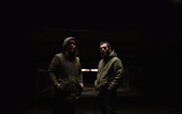 A couple standing together in the darkness.