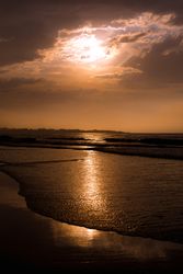 Beautiful evening sky over waving sea and shore