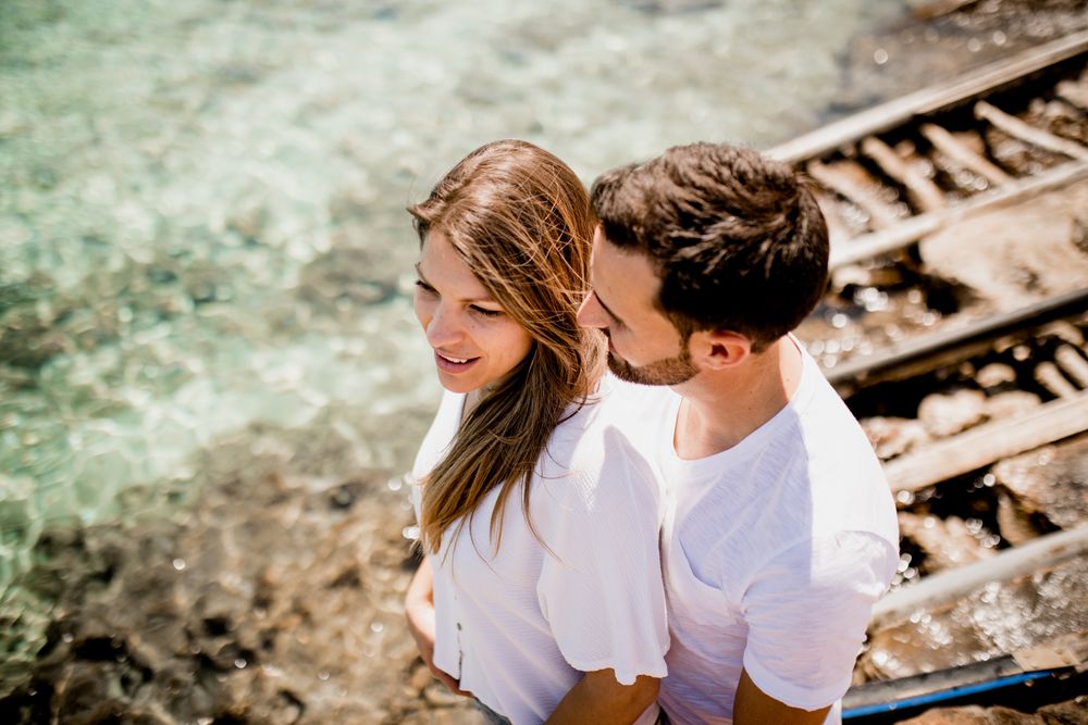 Happy lovers cuddling at cove