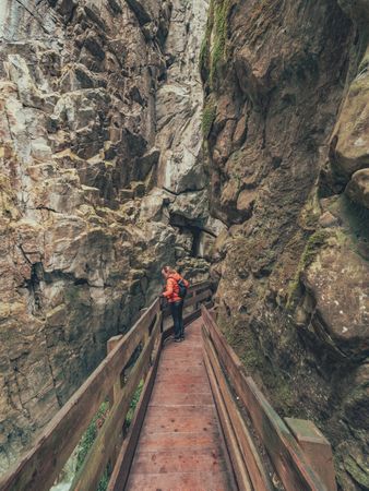 Traveller admiring picturesque view of mountain ridge