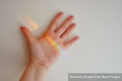 Colorful light reflection on person's hand 49Xgy5