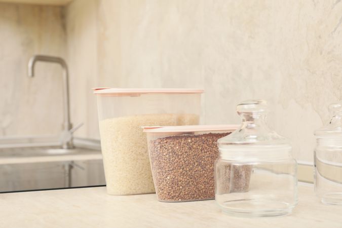 Modern kitchen interior with plastic containers with cereals