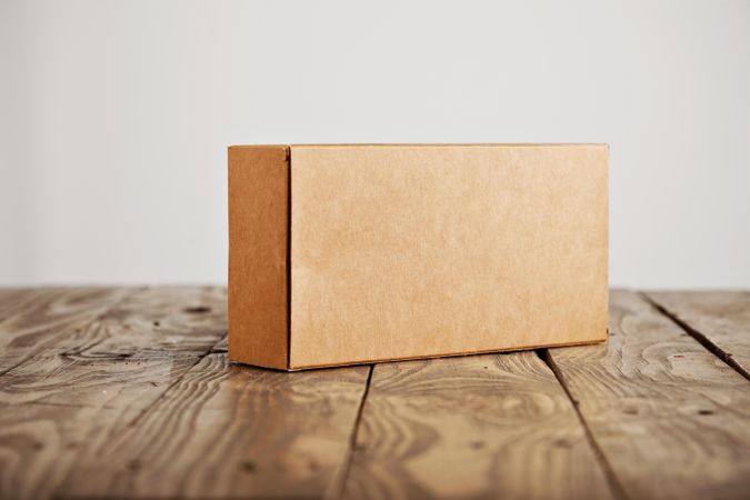 Rectangular cardboard box on wooden table