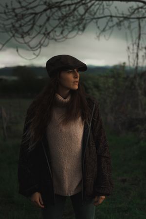 Young woman in warm clothes in forest