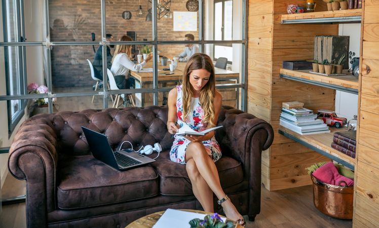 Focused woman working checking her agenda in a coworking office