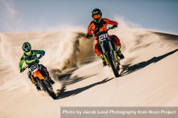 Motocross bikes doing full speed over sand dunes 5wn610