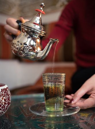 Asian woman enjoying Arabic tea