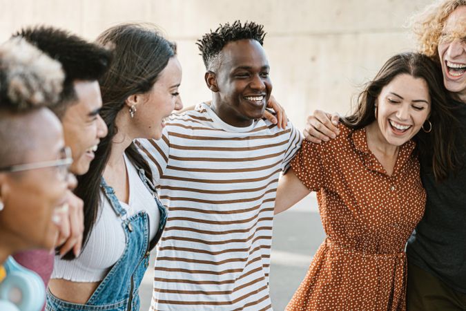 Group of happy multiracial young best friends laughing and having fun together