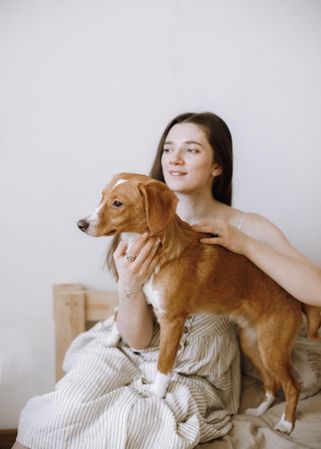 Portrait of a woman and a beagle dog sitting