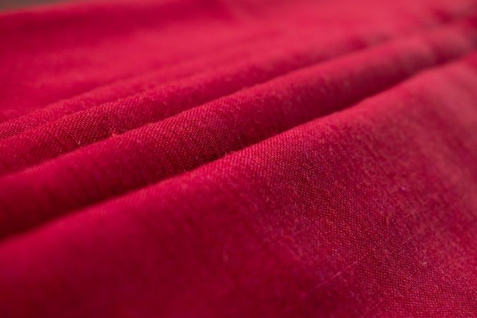 Close up Red fabric folded background texture.