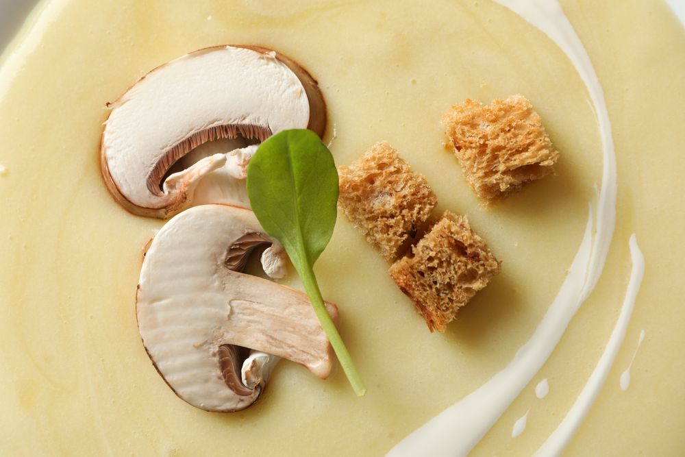 Close up looking down at top of mushroom soup with croutons