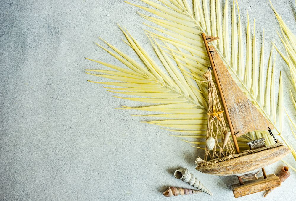 Summer scene with sailboat and seashells
