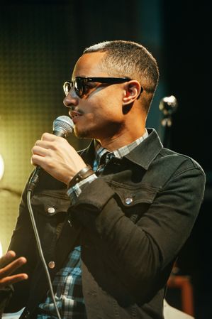 Los Angeles, CA, USA - September 15th, 2014: Man in sunglasses speaking into microphone