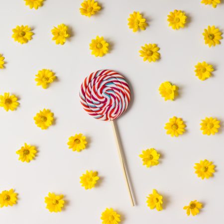 Swirling red lollipop and yellow flowers pattern