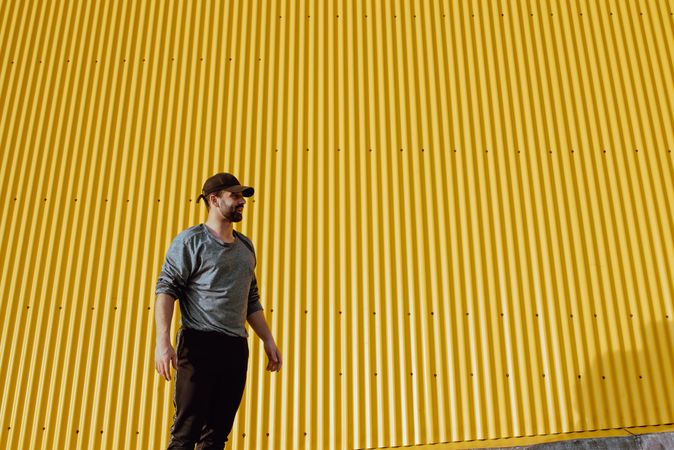 Man standing near yellow wall