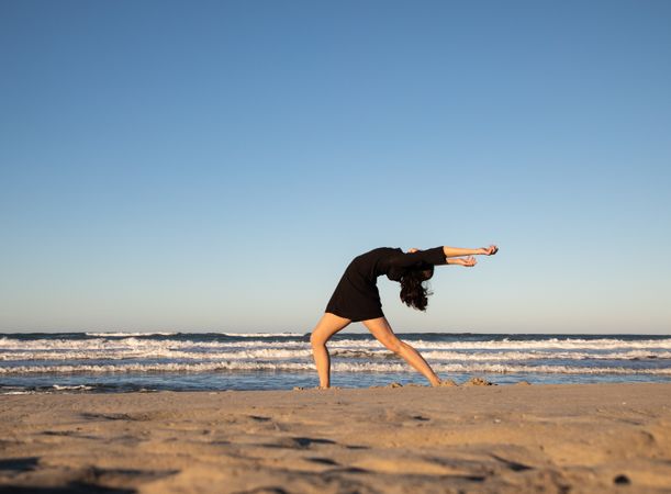 Woman with dancing near water on shore