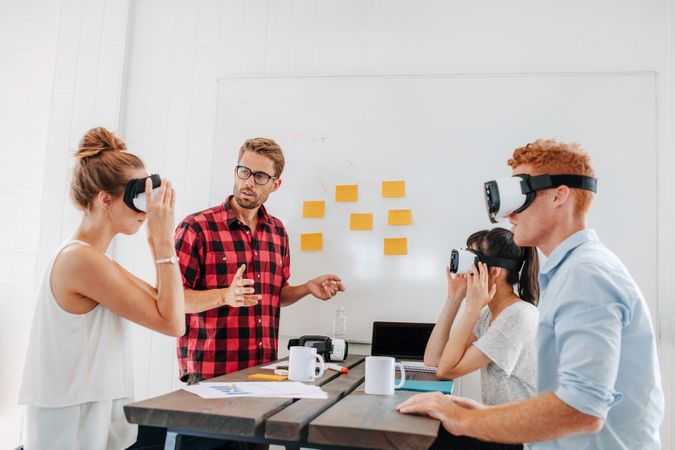 Business team testing virtual reality headset in office meeting