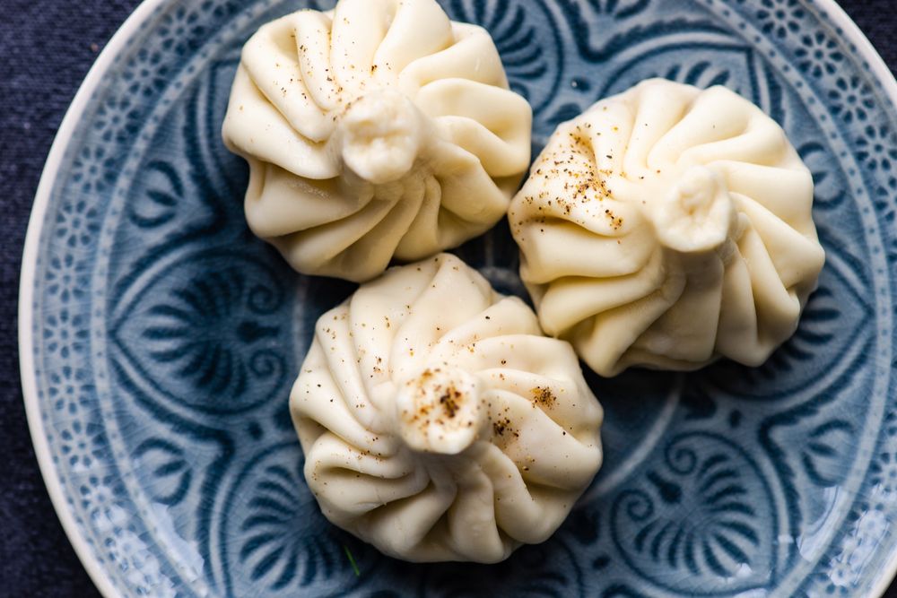 Patterned plate with three Georgian khinkali dumplings