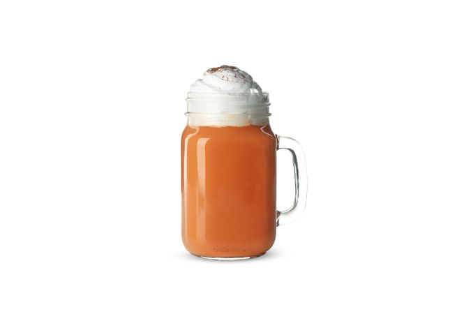 Glass cup of pumpkin latte isolated on neutral background