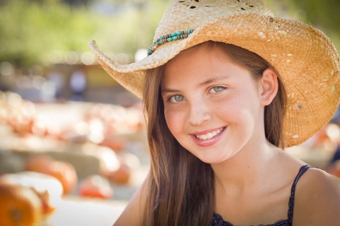 Preteen Girl Portrait Wearing Cowboy Hat at Pumpkin Patch