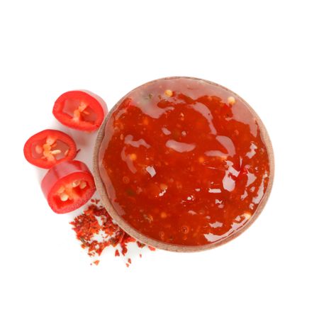 Chilli pepper and bowl of sauce isolated on plain background