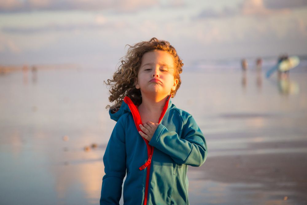 Little girl walking on seashore