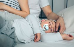 Baby asleep with loving parents