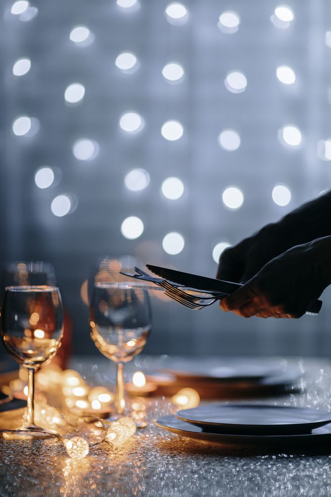 Hands setting utensils for holiday dinner