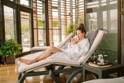Content female relaxing in wellness center
