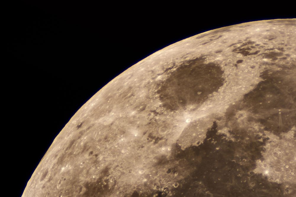 Telescopic close-up of the moon highlighting prominent maria and craters