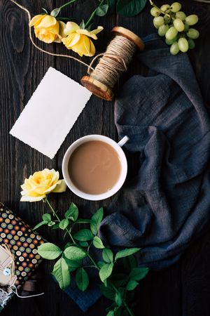 Flowers and empty note near coffee
