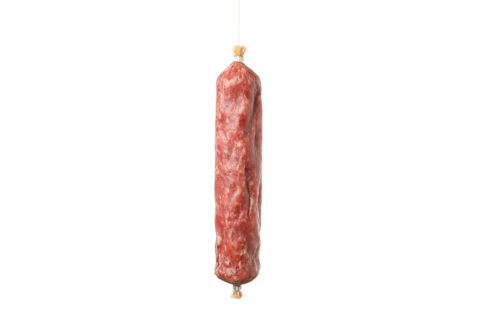 Encased cured meat on plain background