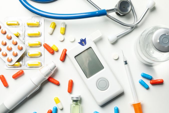 Diabetes accessories on blank background, top view
