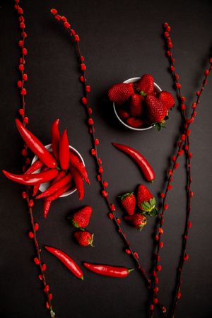 Cloth and branches near peppers and strawberries