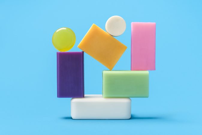 Multicolored soaps stack on a blue background